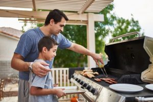 Dad-teaching-son-how-to-grill