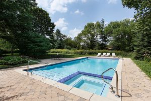 Swimming pool with sauna and flowered landscaping